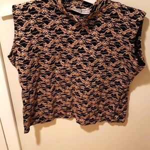Sleeveless gold and black turtle neck shirt